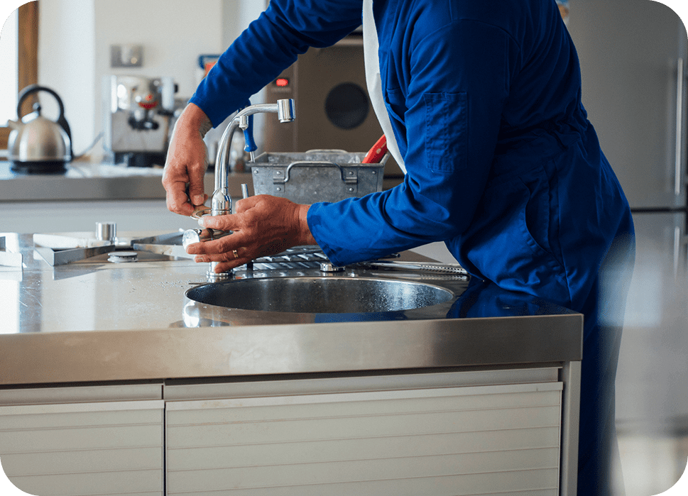 Person repairing a kitchen sink faucet.